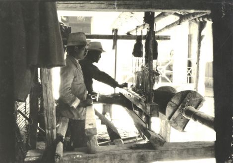 Two men working at a loom