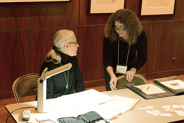 <p>Artists Wendy Brockman and Sue Abramson discussing their work in the gallery workshop, 20 March 2015, photo by Frank A. Reynolds, reproduced by permission of the photographer.</p>